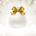 Christmas white bauble with glitter gold bow ribbon and copy space for your greeting or message. Christmas ball on a snow. Royalty Free Stock Photo